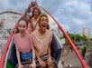 A roller coater car full of people laughing and screaming with excitement as they start to go downhill at Kennywood.