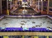 Indoor aquariums with marine life at an exhibit, featuring tiled edges and warning signs visible in the background.