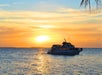 Glass Bottom Boat returning to port in Key West, Florida as the sun sets.