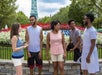 A family standing in front of a flower garden chatting on a sunny day at Kings Dominion in Doswell, Virginia.