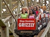 The Grizzly roller coaster full of people laughing and enjoying the ride at Kings Dominion in Doswell, Virginia.