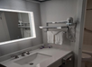 Guest bathroom with a lighted mirror, hair dryer, free toiletries, and fresh towels.