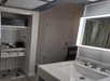 Cozy guest room with an in-room safe, coffee maker, fresh towels and a laundry basket.