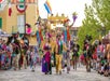 A large mardi gras parade as sunset  at King's Island in Cincinnati, Ohio.