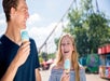 A young man and woman eating blue ice cream cones  at King's Island in Cincinnati, Ohio.