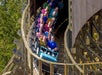 A car full of people going around the corner on the Mystic Timber coaster  at King's Island in Cincinnati, Ohio.