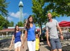 A family of four walking on a sunny day  at King's Island in Cincinnati, Ohio.