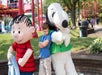A young boy posing with Snoopy and Linus at King's Island in Cincinnati, Ohio.