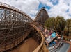 A car full of people screaming on the Ghostrider roller coaster on a sunny day at Knott's Berry Farm near Los Angeles, California.