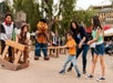 A family playing tug-of-war with cast members at Knott's Berry Farm in Buena Park, California.