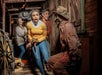 Three people react in fear as they encounter a costumed performer dressed as a cowboy in a dimly lit, rustic corridor.