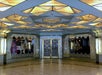 An ornate entrance with art deco design elements, featuring geometric patterns, double glass doors, and the word "Cicada" displayed above.