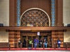 The entrance of Union Station features people standing and walking, with an ornate architectural design and prominent sign.