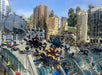 A colorful Lego display at Legoland California's MINILAND, showcasing intricately designed skyscrapers and buildings, all crawling with colorful Lego spiders that add a whimsical touch to the urban landscape.