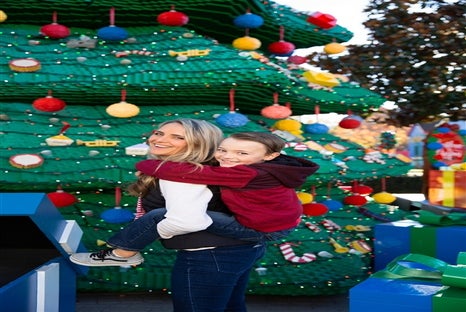 A mom and son if front of a Lego Christmas tree at LEGOLAND Florida Resort.