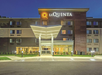 Front view of a La Quinta hotel building at dusk, with a well-lit entrance and visible logo.