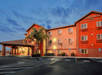 Hotel exterior with parking space.