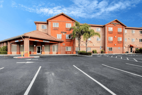 Hotel exterior with parking space.