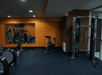 Fitness room with cardio equipment and weights.