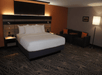 One king bed and comfortable sofa inside a guest room.