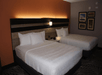 Two queen beds with plush bedding inside a non-smoking room.