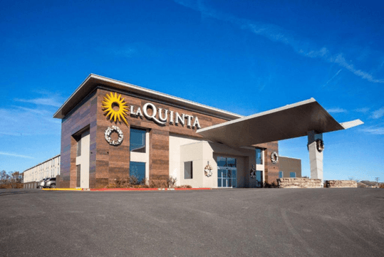 Entrance to the hotel with the hotel sign, La Quinta by Wyndham Branson.
