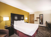 One king bed and desk in a guest room.