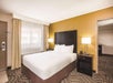 One queen bed inside a guest room.