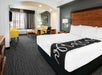 One king bed and a spacious seating area inside a non-smoking suite.