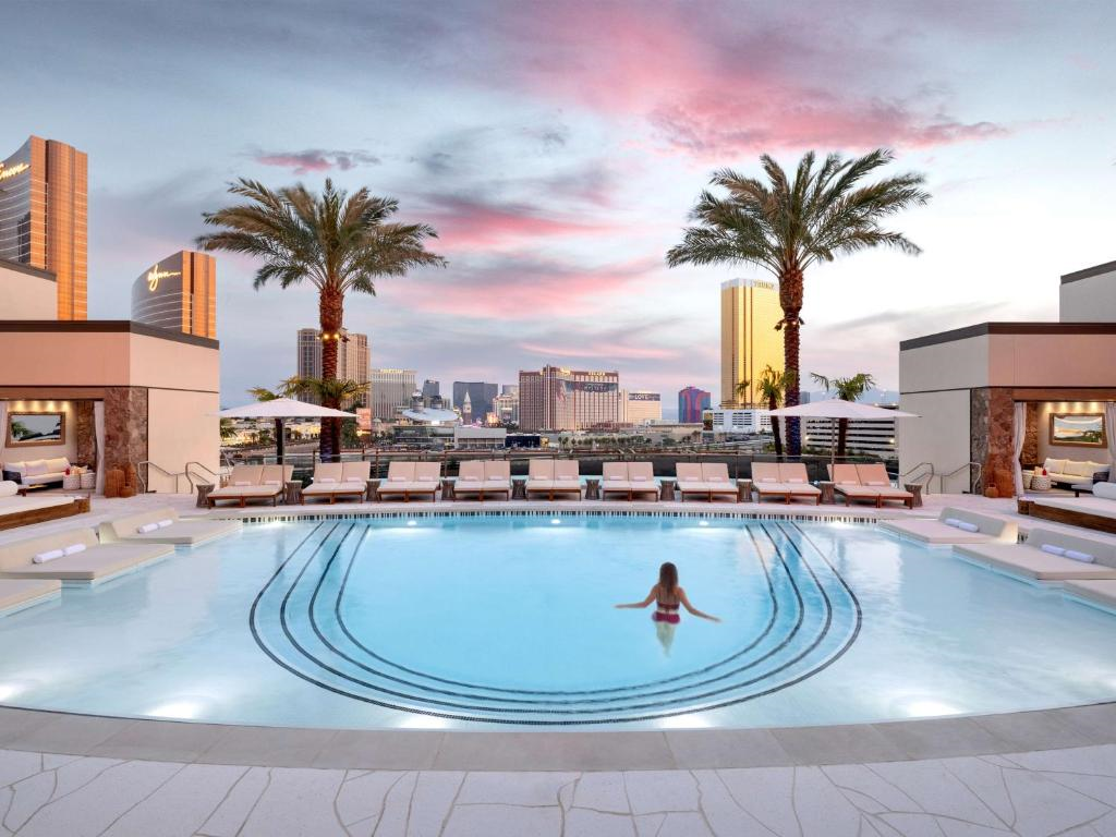 Outdoor pool with sun loungers.