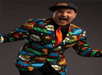 Lefty in a suit covered in comic books style onomatopoeias performing at the Late Night Magic Las Vegas.