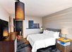 One king bed, flat-screen TV and a work desk inside a guest room.