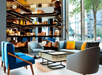 Beautifully decorated common area with a sofa and floor-to-ceiling windows.