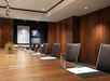 Meeting facility with long table and executive chairs.