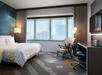 Guest room with one king bed, flat-screen TV, and work desk.