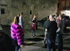 Outside in a parking lot, the Lewd Spirits Tour Guide shares a story.