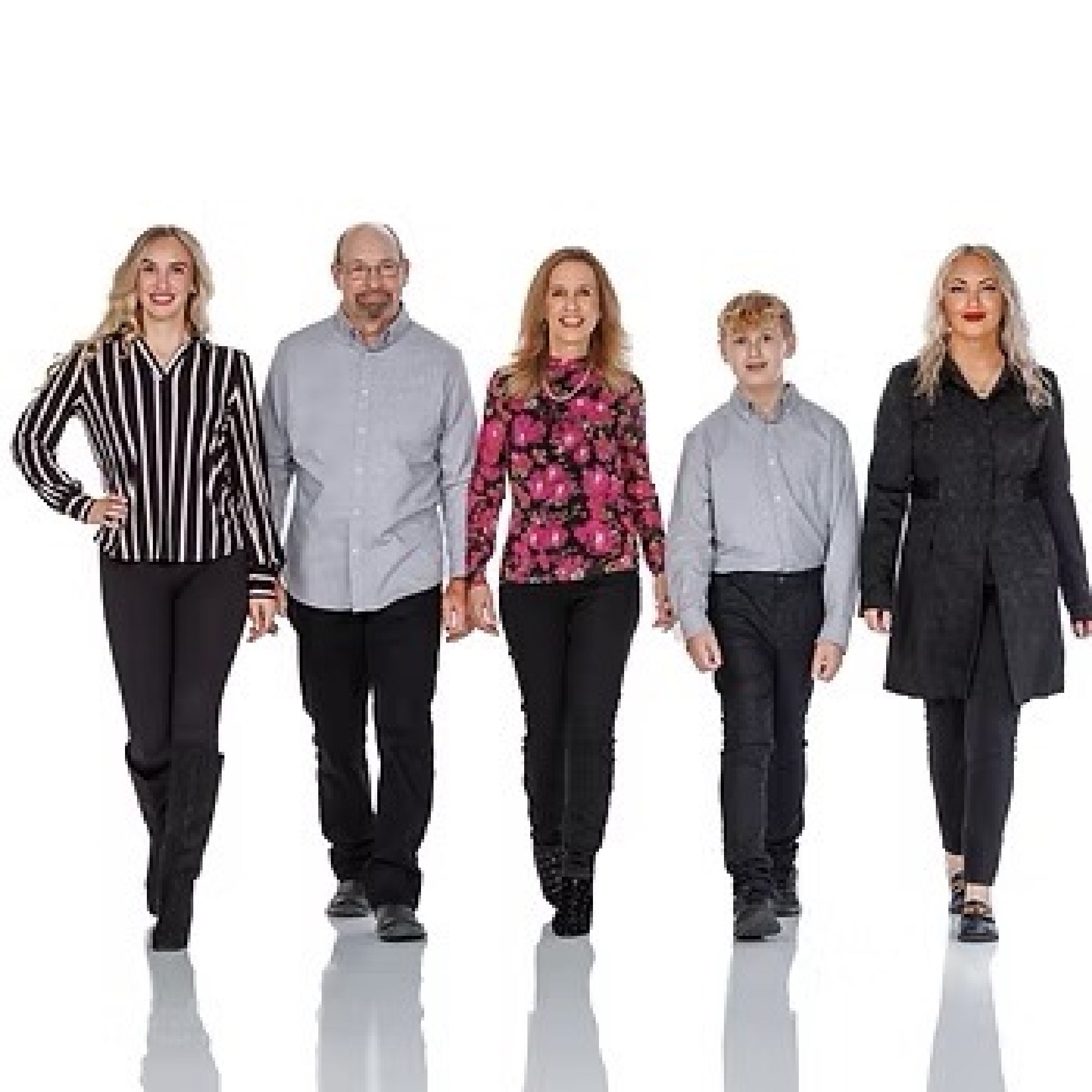 Five people, three women, one man, and one boy, stand in a row against a white background, all dressed in coordinated black and gray outfits.