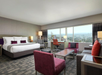 A perfect blend of comfort and productivity with one king bed, a seating area, a work desk, and an expansive window.