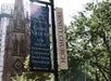 Two signs near trees and buildings read "Trinity Church Wall Street Core Values" and list values, with a church building visible in the background.