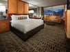 One king bed, seating area, and flat-screen TV inside a guest room.