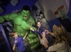 A mother taking a photo of her children posing with the Hulk at Madame Tussauds in Las Vegas, Nevada.
