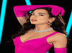 A close up shot of a Dua Lipa wax figure at Madame Tussauds Orlando styled in a custom fuchsia lace catsuit with matching gloves, inspired by the Balenciaga ensemble she wore on her Future Nostalgia tour.
