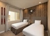 Twin bed inside one of the rooms in a guest unit at Magic Village Views.