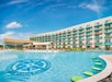 Outdoor swimming pool with a compass design at the bottom, surrounded by loungers, in front of a hotel building under a blue sky in Kansas City.