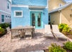 Private patio with outdoor dining and lounge chairs.