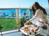 Guest eating breakfast in the balcony with a view of the marina.