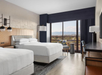 Relax in comfort with two double beds and plenty of natural light from a large window.
