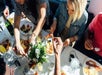 People gathered around a full brunch table helping themselves to what they want on the Marina del Rey Brunch Cruise.