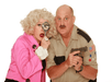 A person with curly hair and a magnifying glass stands beside another person in uniform holding a toy gun.