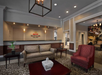 Hotel lobby with sofas, a patterned rug, and a reception desk. A "Marriott Vacation Club" sign is on the wall behind the desk.